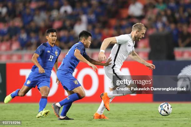 Adam Nemec of Slovakia dribbles the ball away from Thitiphan Puangjan of Thailand during the international friendly match between Thailand and...