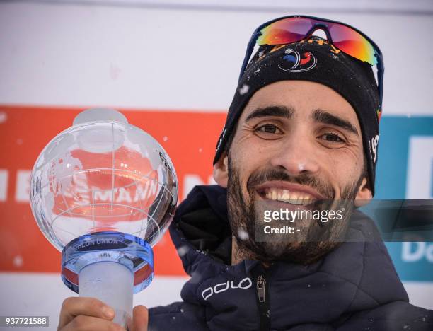 France's Martin Fourcade poses with the crystal globe trophy following the Men 15km Mass Start Competition event at the IBU Biathlon World Cup Final...