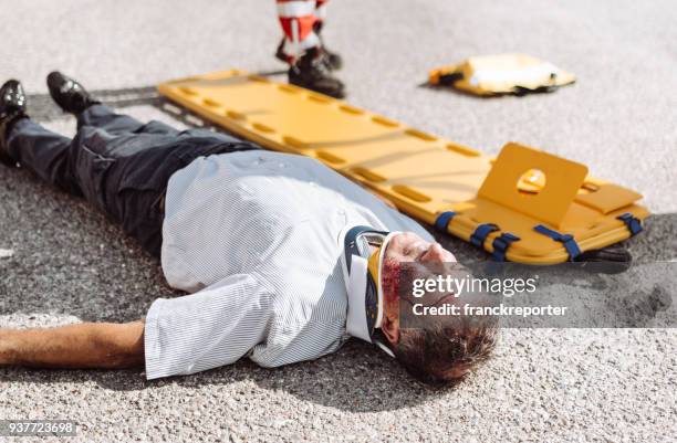 man on the ground after a car crash - motorcycle crash stock pictures, royalty-free photos & images