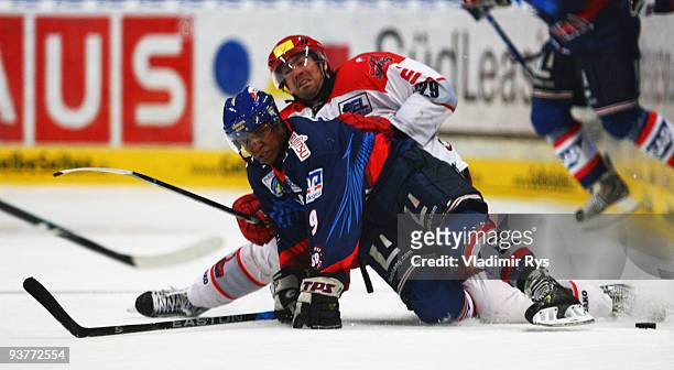 Nathan Robinson of Adler and Tore Vikingstad of Scorpions battle for the puck during the Deutsche Eishockey Liga game between Adler Mannheim and...