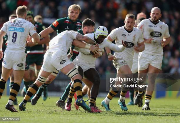 Christian Wade of Wasps is held by Adam Thompstone during the Aviva Premiership match between Leicester Tigers and Wasps at Welford Road on March 25,...