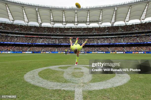 Umpire Nick Foot practices a centre bounce before the round one AFL match between the West Coast Eagles and the Sydney Swans at Optus Stadium on...