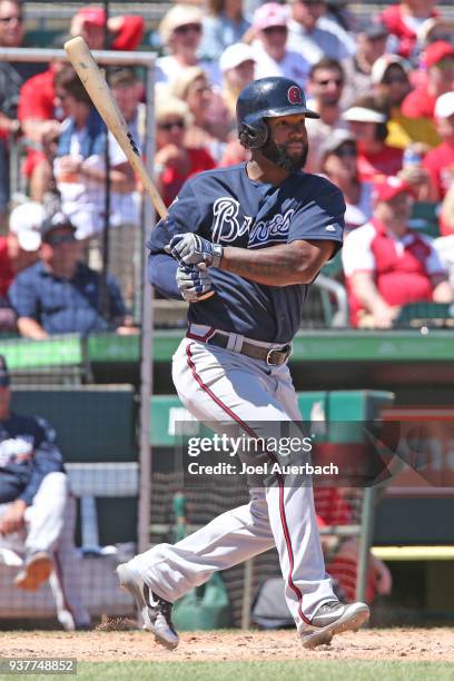 Danny Santana of the Atlanta Braves hits the ball against the St Louis Cardinals during a spring training game at Roger Dean Chevrolet Stadium on...