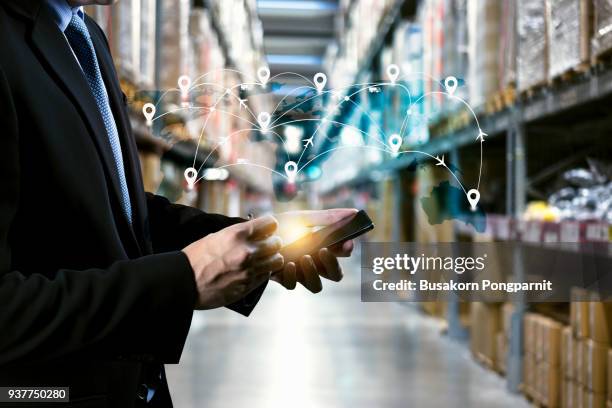 male manager hand holding tablet with ar application for check order pick time in smart factory warehouse, technology interface global partner connection for logistic import export background - international shipping stock-fotos und bilder