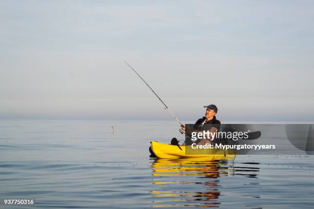 fishing on calm and sunny seas - kayak stock pictures, royalty-free photos & images