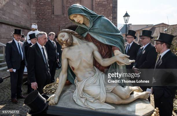 Participants stand next to an effigy of Jesus and wait for the beginning of the annual Palm Sunday procession on March 25, 2018 in Heiligenstadt,...