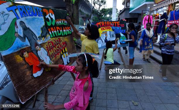 Students of Gurukul School of Art draw a painting to pay tribute to 39 Indians who died in Mosul, Iraq and terror attack victims of France at Lalbaug...