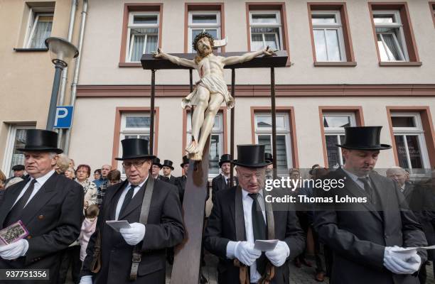 Participants stand next to an effigy of Jesus nailed to the cross during the annual Palm Sunday procession on March 25, 2018 in Heiligenstadt,...