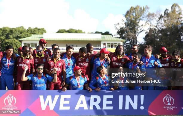 The victorious Afghanistan team mis with West Indian players after winning The ICC Cricket World Cup Qualifier Final between The West Indies and...