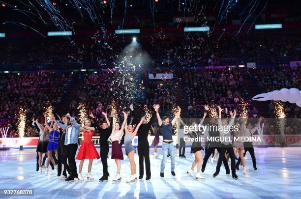 Skaters wave to the audience at an Exhibition Gala at The World Figure Skating Championships 2018 in Milan on March 25, 2018. / AFP PHOTO / MIGUEL...