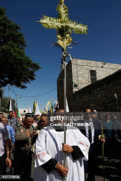 Catholic worshippers take part in the traditional Palm Sunday procession from Mount of Olives to Jerusalem's Old City on March 25, 2018. The ceremony...