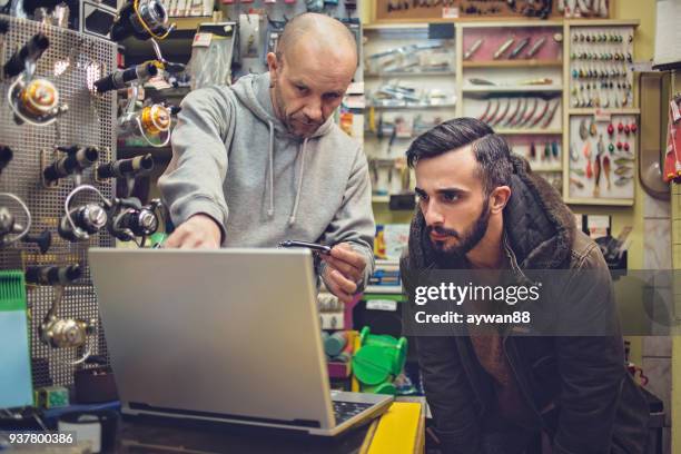 fisherman buying new fishing equipment - fishing bait stock pictures, royalty-free photos & images