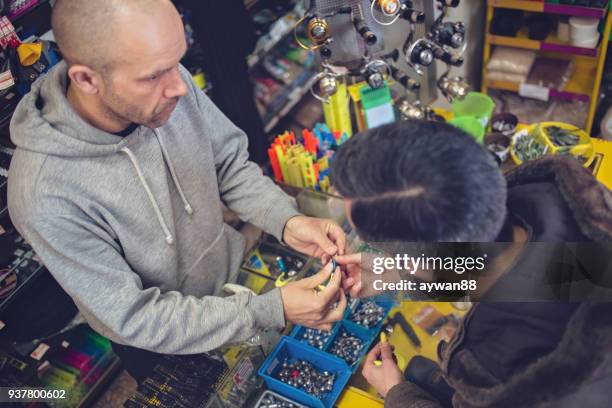 fisherman buying fishing bait - barbed hook stock pictures, royalty-free photos & images