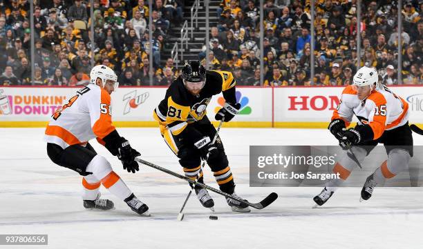Phil Kessel of the Pittsburgh Penguins handles the puck between Valtteri Filppula of the Philadelphia Flyers and Jori Lehtera of the Philadelphia...