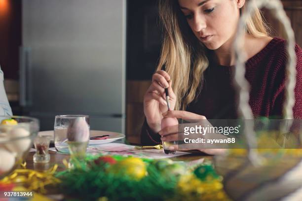 young beautiful woman coloring eggs for easter - decoupage stock pictures, royalty-free photos & images