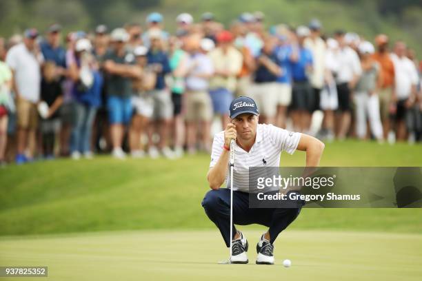 Justin Thomas of the United States lines up a putt on the 15th green during his semifinal round match against Bubba Watson of the United States in...
