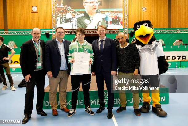 People pose as awards are handed out during the DFB Indoor Football ceremony on March 25, 2018 in Gevelsberg, Germany.