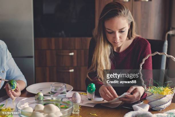 young woman coloring eggs for easter - decoupage stock pictures, royalty-free photos & images
