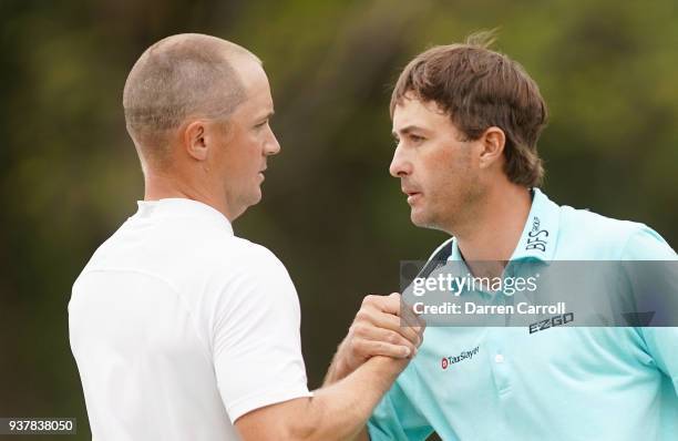 Kevin Kisner of the United States shakes hands with Alexander Noren of Sweden after defeating him in a playoff on the 12th hole during the semifinal...