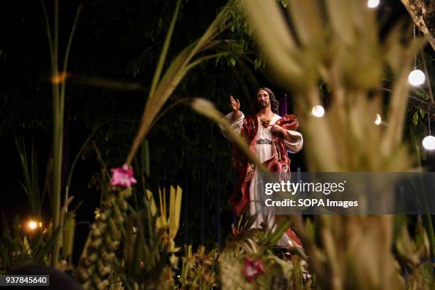 Statue of Jesus Christ seen above a sea of palm fronds outside Antipolo church, Rizal province, east of Manila. Catholic devotees mark the start of...