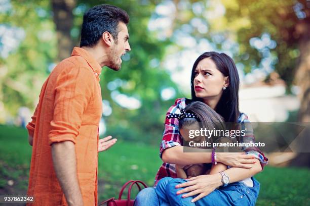 husband is arguing with wife at the front of their little daughter - family violence stock pictures, royalty-free photos & images