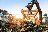 Grab crane works in waste recycling station
