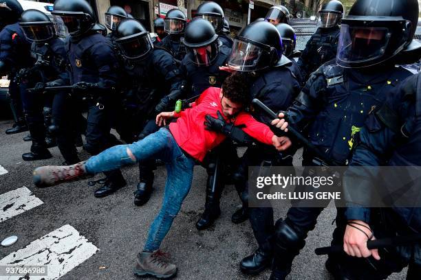 Protester falls after being pulled by riot police blocking the road leading to the central government offices during scuffles at a demonstration in...