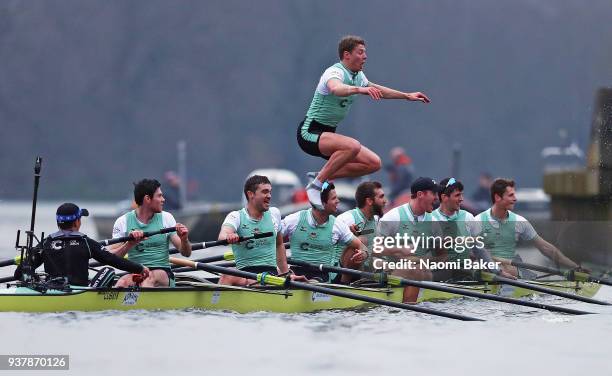 Rob Hurn jumps from the boat as the Cambridge University Men's Boat Club Blue crew celebrate race victory over Oxford University Men's Boat Club Blue...