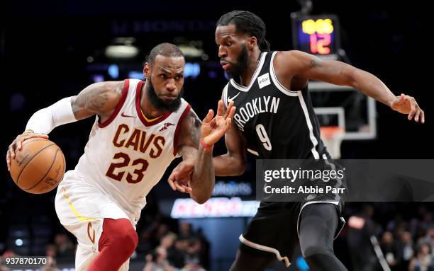 LeBron James of the Cleveland Cavaliers dribbles to the basket against DeMarre Carroll of the Brooklyn Nets in the third quarter during their game at...
