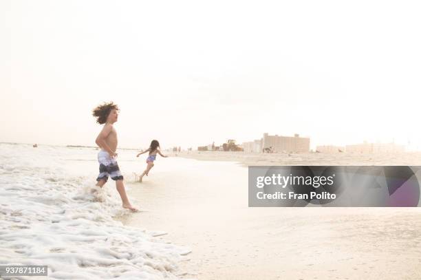 children at the beach. - long beach new york stockfoto's en -beelden