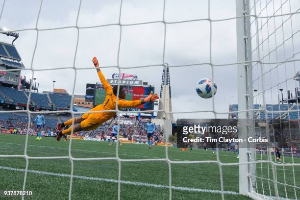 March 24: Diego Fagundez of New England Revolution shot beats goalkeeper Sean Johnson of New York City to go in off the post for an early goal during...