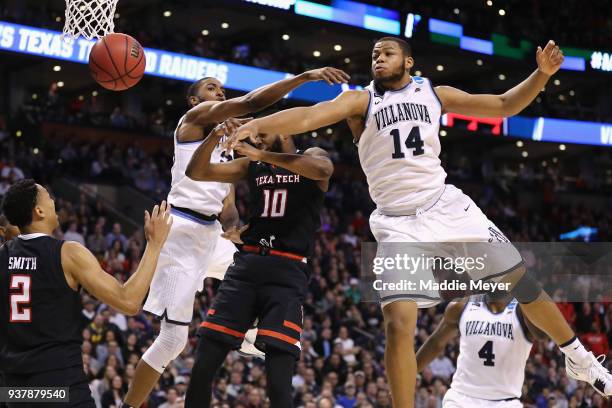 Mikal Bridges and Omari Spellman of the Villanova Wildcats knock the ball away from Niem Stevenson of the Texas Tech Red Raiders during the second...