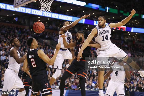 Mikal Bridges and Omari Spellman of the Villanova Wildcats knock the ball away from Niem Stevenson of the Texas Tech Red Raiders during the second...