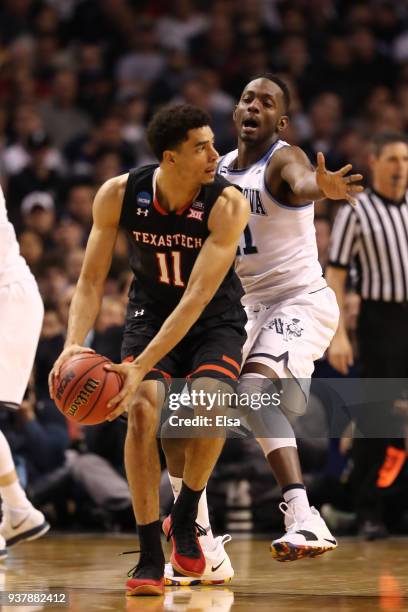 Zach Smith of the Texas Tech Red Raiders is defended by Dhamir Cosby-Roundtree of the Villanova Wildcats during the second half in the 2018 NCAA...