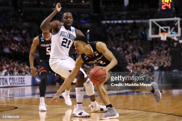 Zhaire Smith of the Texas Tech Red Raiders is defended by Dhamir Cosby-Roundtree of the Villanova Wildcats during the second half in the 2018 NCAA...