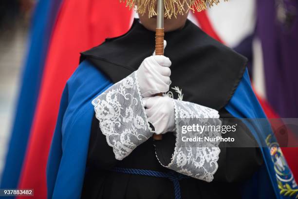 Detail of the hands of a child who carried the banner of the brotherhood, during the children's procession that took place in Santander, during his...