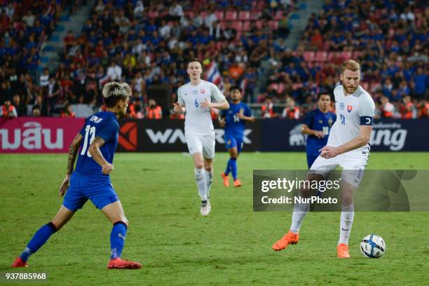 Adam Nemec of Slovakia, and Thailand's Philip Roller for the ball during their King Cup 46th soccer final match at Rajamangala national stadium in...