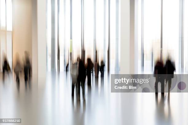 silhouettes of people in a modern interior - museum entrance stock pictures, royalty-free photos & images