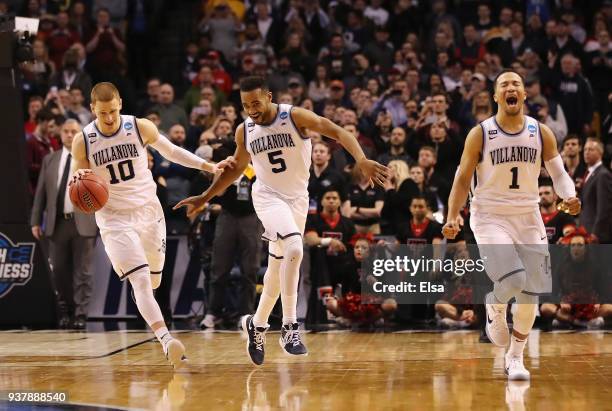 Donte DiVincenzo, Phil Booth, and Jalen Brunson of the Villanova Wildcats celebrate defeating the Texas Tech Red Raiders 71-59 in the 2018 NCAA Men's...