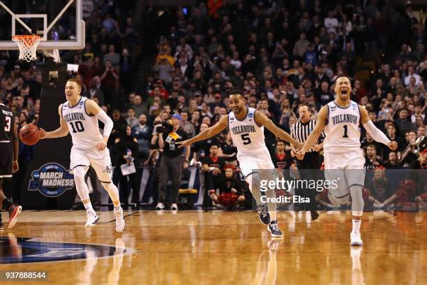 Donte DiVincenzo, Phil Booth, and Jalen Brunson of the Villanova Wildcats celebrate defeating the Texas Tech Red Raiders 71-59 in the 2018 NCAA Men's...