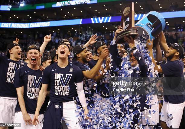 The Villanova Wildcats celebrate with head coach Jay Wright and the East Regional Champion trophy after defeating the Texas Tech Red Raiders 71-59 in...