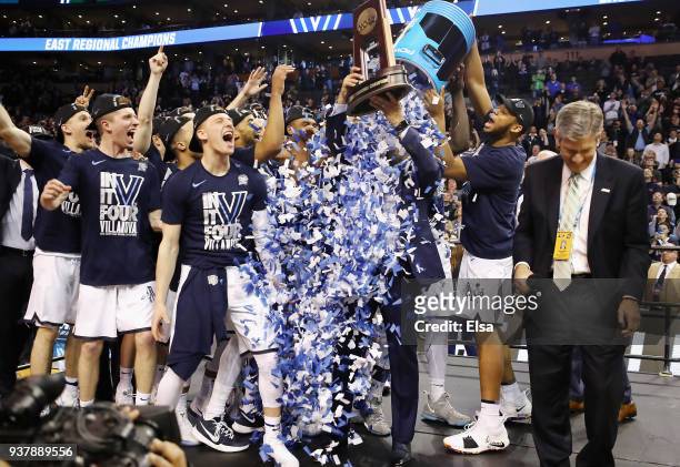 The Villanova Wildcats celebrate with head coach Jay Wright and the East Regional Champion trophy after defeating the Texas Tech Red Raiders 71-59 in...