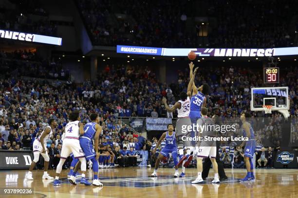 Udoka Azubuike of the Kansas Jayhawks tips off against Marvin Bagley III of the Duke Blue Devils to start the first half in the 2018 NCAA Men's...