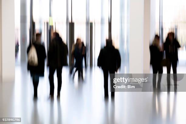 silhouettes of people in a modern interior - bokeh museum stock pictures, royalty-free photos & images