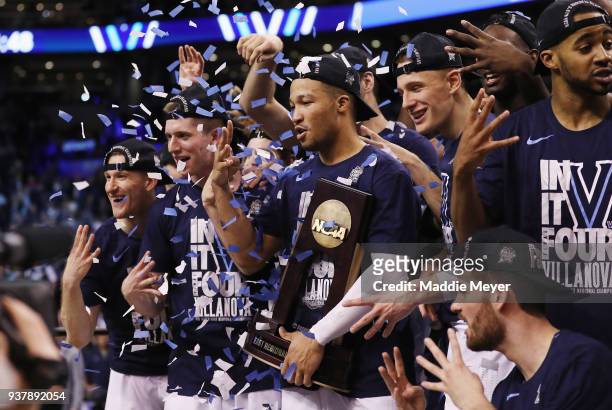 Jalen Brunson of the Villanova Wildcats celebrates with the East Regional Champion trophy after defeating the Texas Tech Red Raiders 71-59 in the...