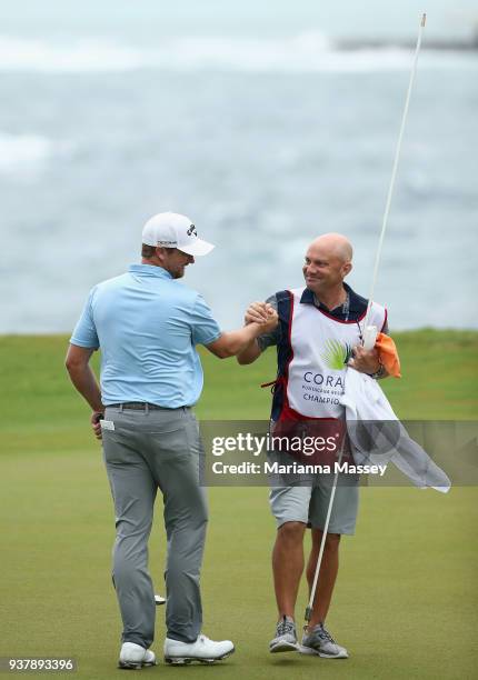 Brice Garnett with his caddie Chris Callas after putting in to win on the 18th green during the final round of the Corales Puntacana Resort & Club...