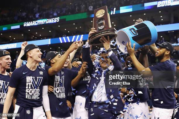 Head coach Jay Wright of the Villanova Wildcats holds the East Regional Champion trophy after defeating the Texas Tech Red Raiders 71-59 in the 2018...
