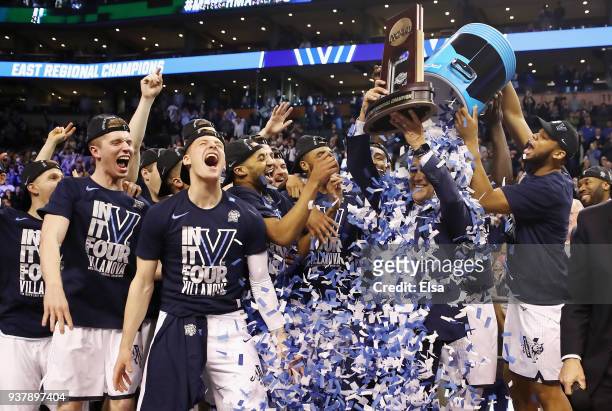Head coach Jay Wright of the Villanova Wildcats holds the East Regional Champion trophy after defeating the Texas Tech Red Raiders 71-59 in the 2018...