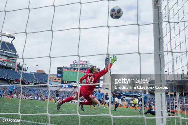 March 24: Ismael Tajouri-Shradi of New York City scores the second of his two goals beating goalkeeper Matt Turner of New England Revolution during...