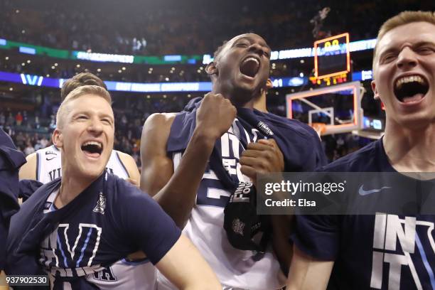 Denny Grace, Dhamir Cosby-Roundtree and Matt Kennedy of the Villanova Wildcats celebrate after defeating the Texas Tech Red Raiders 71-59 in the 2018...